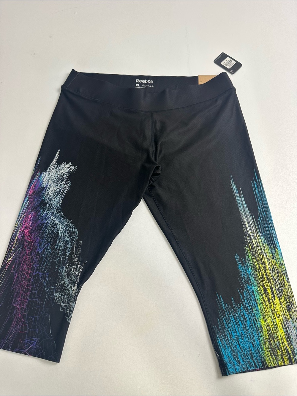 Reebok women’s XL Black Capri Leggings with Multicolor Graphic new with tags